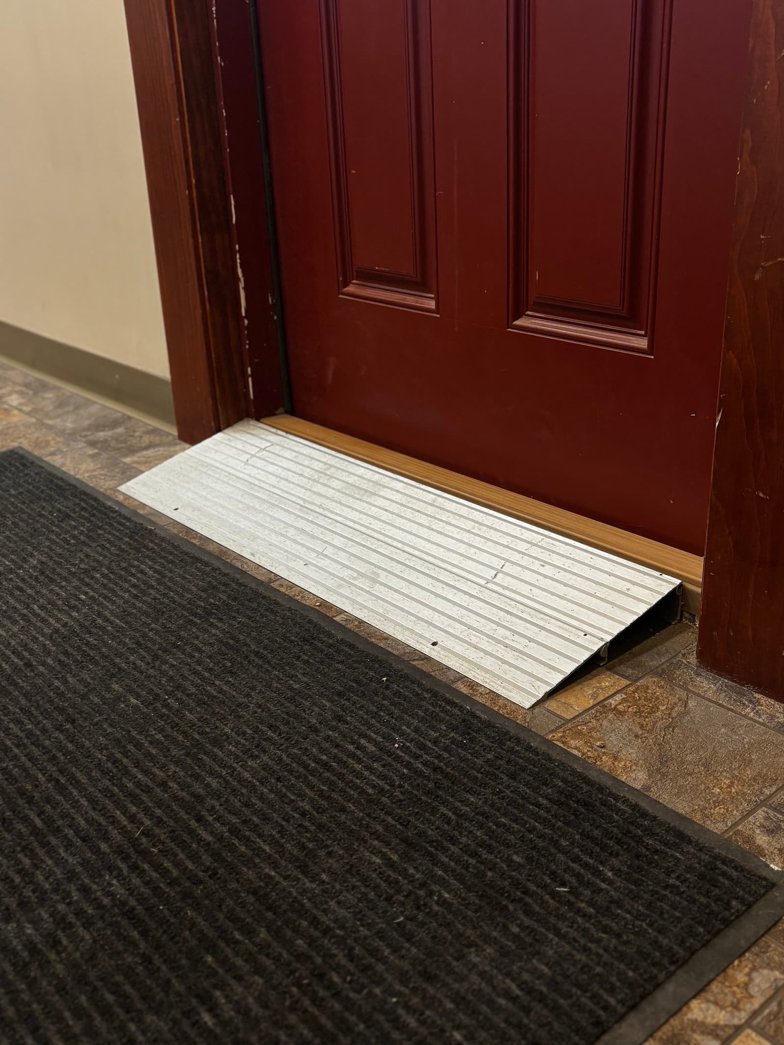 A clean, code-compliant entry ramp leading to a door.